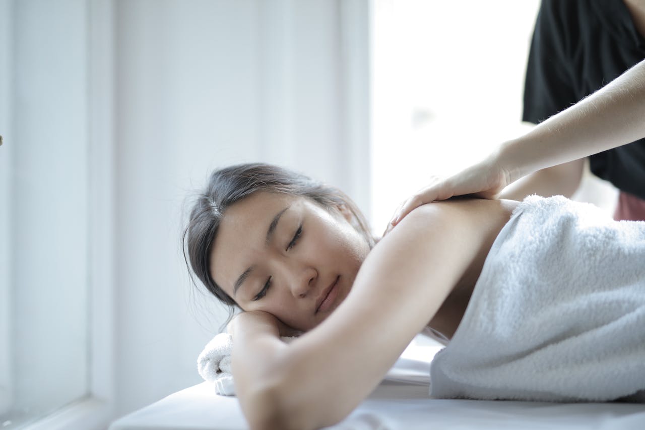 A massage therapist applies focused, deep pressure massage to address chronic muscle tension.