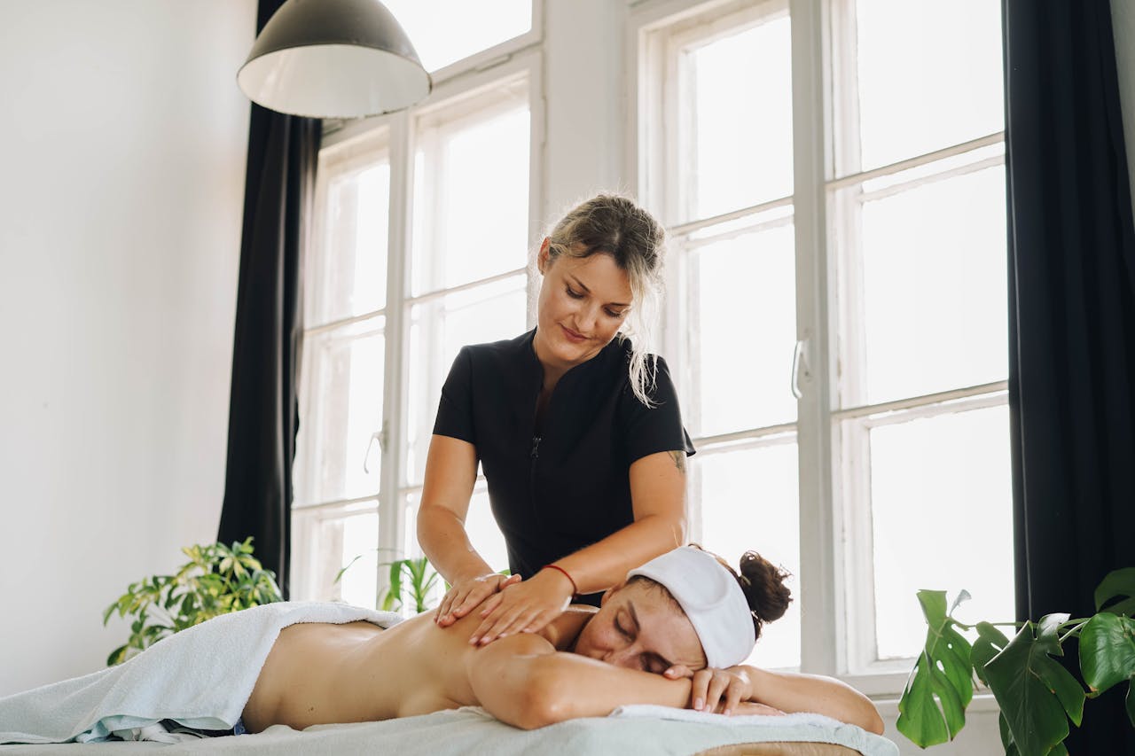 A therapist and client communicate about pressure and comfort during a deep tissue massage session.