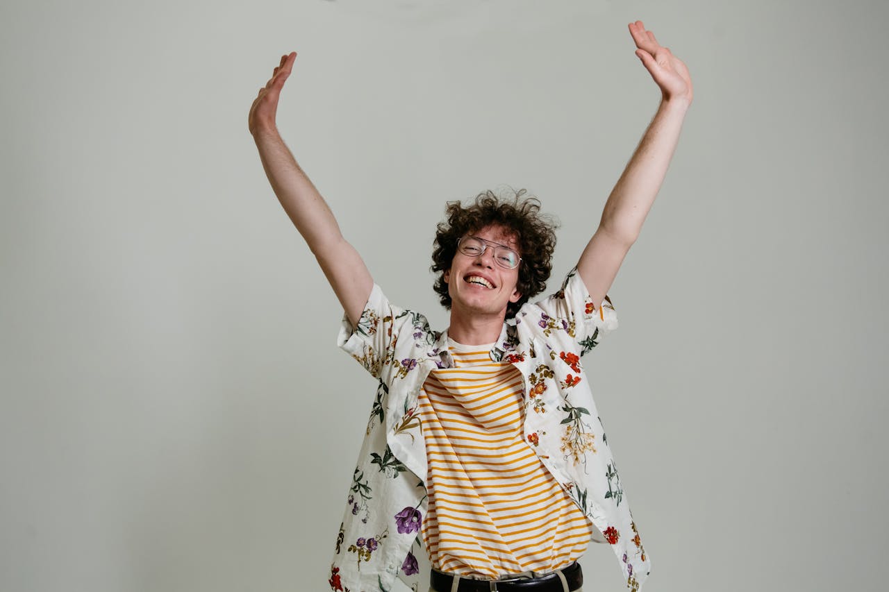 A satisfied client smiling and reaching upward effortlessly, demonstrating restored mobility and freedom from pain