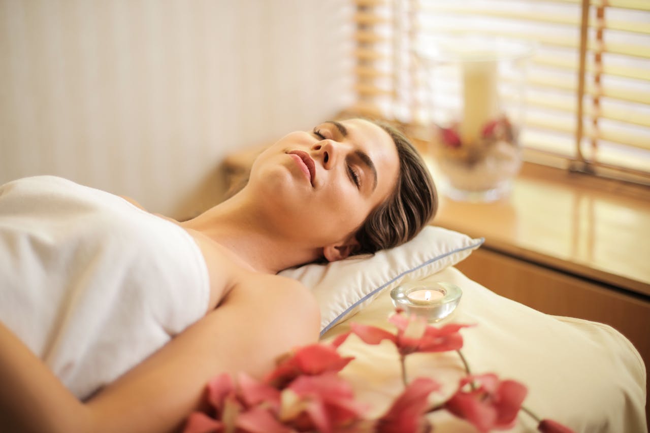 A client rests peacefully and is wrapped in warmth after a relaxing Swedish massage session.