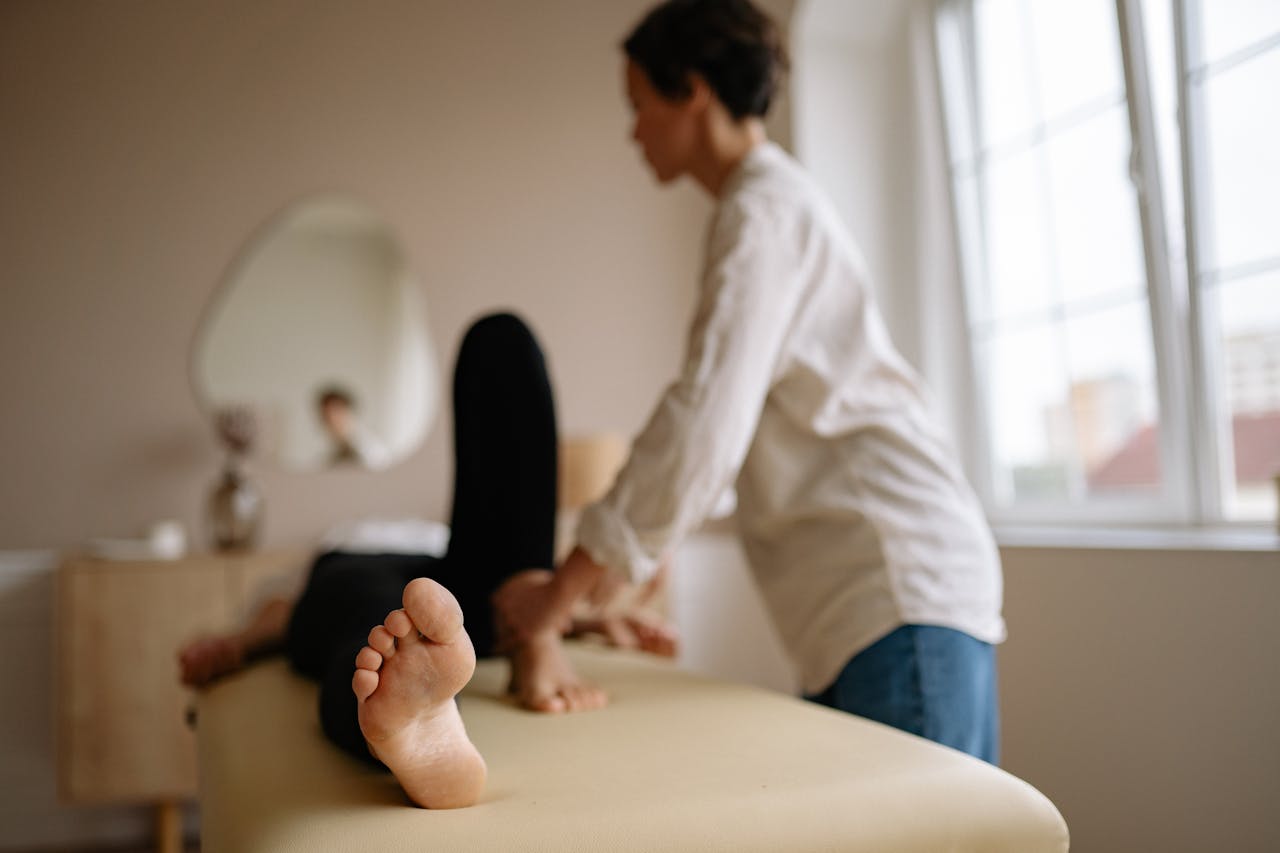 A client and therapist work together during a total body stretching therapy session, emphasizing collaboration.