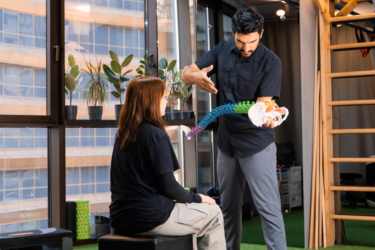 Massage therapist explaining how traction therapy can help